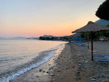 Scenic view of beach against sky during sunset