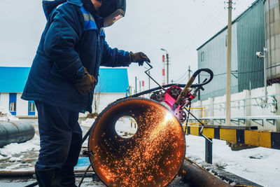 Side view of man working at construction site