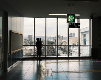 Woman walking in illuminated corridor