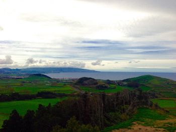 Scenic view of landscape against cloudy sky