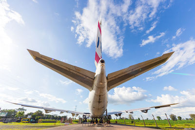 Rear view at airplane standing on parking from low angle