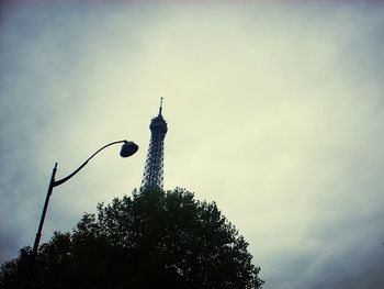 Low angle view of tower against cloudy sky