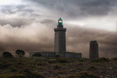 Lighthouse and buildings against sky