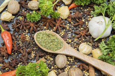 High angle view of spices in wooden spoon