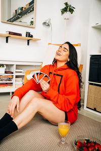 Young woman sitting on table