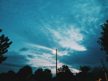 Low angle view of silhouette trees against sky