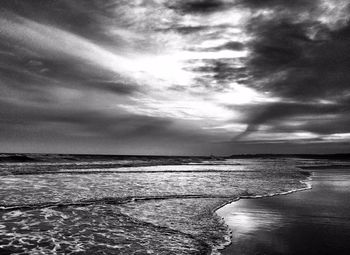 Scenic view of sea against cloudy sky