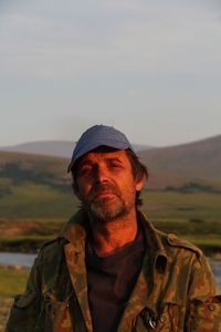 Portrait of man standing against outdoors during sunset