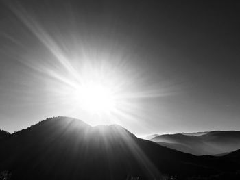 Sun shining over mountains