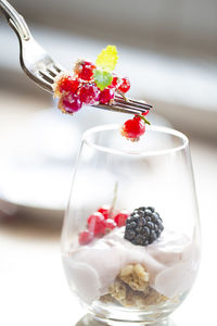 Close-up of yogurt and fruits in drinking glass