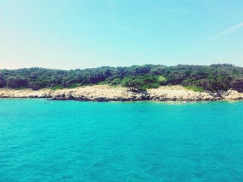 Scenic view of sea against clear blue sky