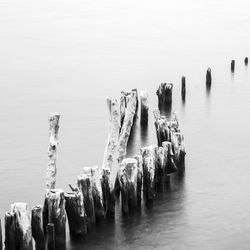 Panoramic view of groyne in sea against sky