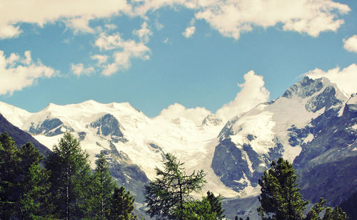 Scenic view of mountains against cloudy sky