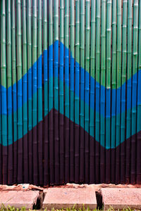 Metal gate against blue wall