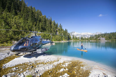 Man on boat in lake against sky