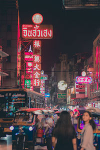 People on city street at night