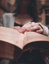 Midsection of woman reading book