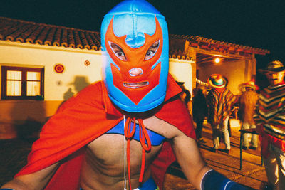 Portrait of man with illuminated lighting equipment at night