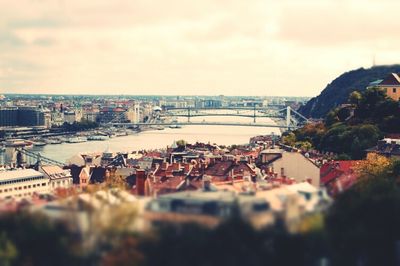 Bridge over river against cloudy sky