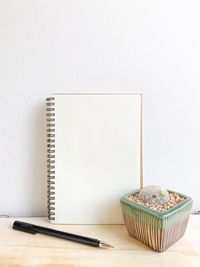 Close-up of book on table against white background