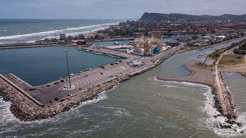 High angle view of sea and cityscape against sky