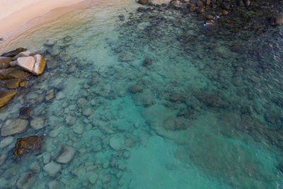 High angle view of rocks by sea