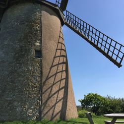 Low angle view of traditional windmill against sky