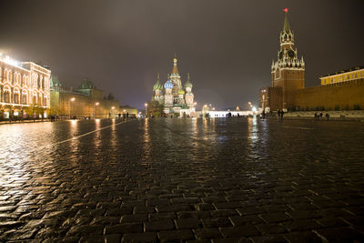 Illuminated st basil cathedral in front of walkway at night