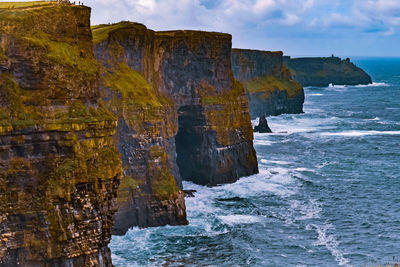 Scenic view of rock formation in sea against sky