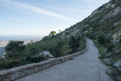 Road by sea against sky