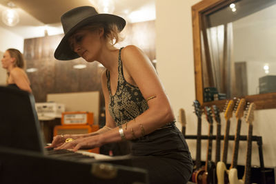 Young female musician playing a keyboard