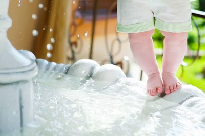 Low section of child on fountain