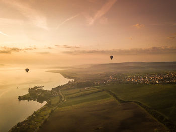 View of hot air balloon flying over landscape