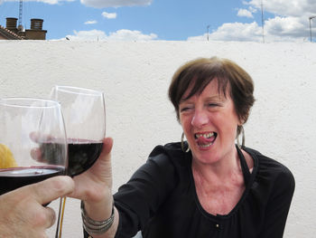 Smiling woman toasting wineglass