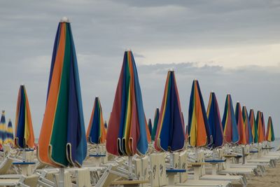 Multi colored chairs on table against sky