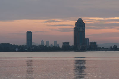 View of buildings in city during sunset