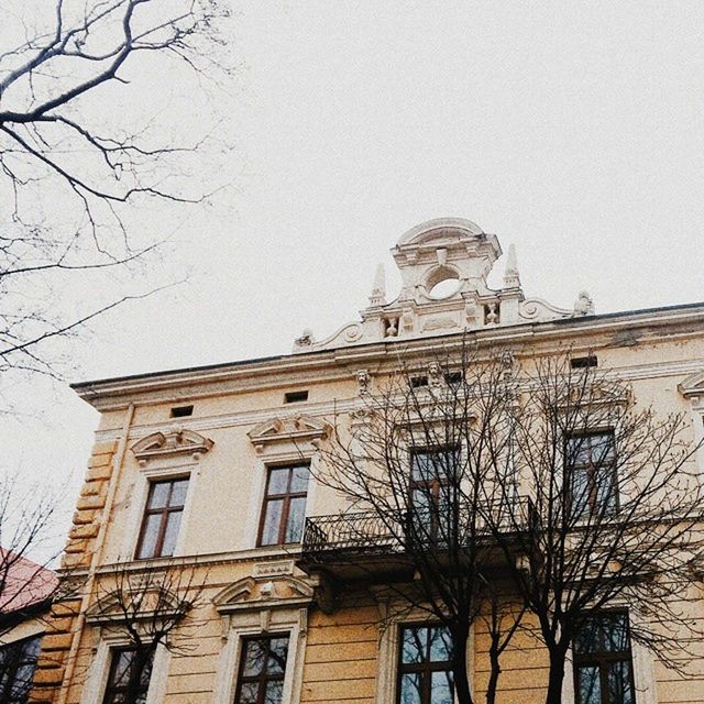 architecture, building exterior, built structure, low angle view, clear sky, window, bare tree, sky, religion, place of worship, day, city, church, building, history, outdoors, old, no people, spirituality