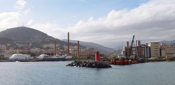 Panoramic view of boats in sea against buildings