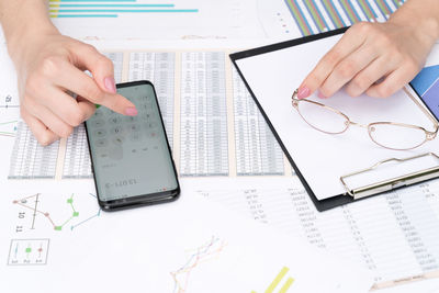 Midsection of person reading book on table