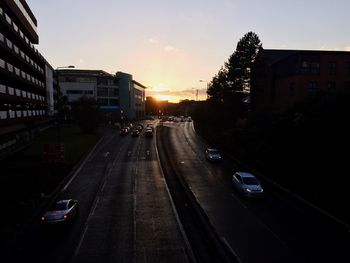 Traffic on road at sunset