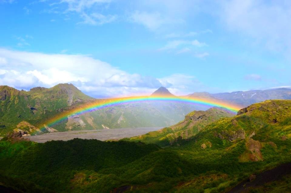 mountain, sky, scenics, landscape, tranquil scene, beauty in nature, tranquility, cloud - sky, nature, blue, mountain range, non-urban scene, idyllic, cloud, rainbow, remote, transportation, green color, day, outdoors