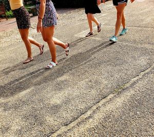 Low section of women walking outdoors