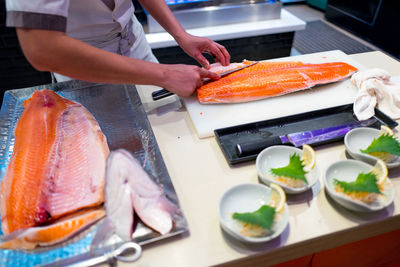 Man preparing food on table