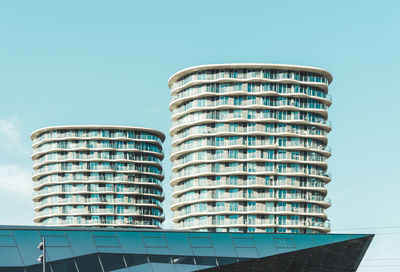 Low angle view of modern building against clear blue sky