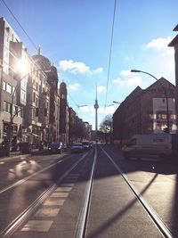 Cars on road in city against sky