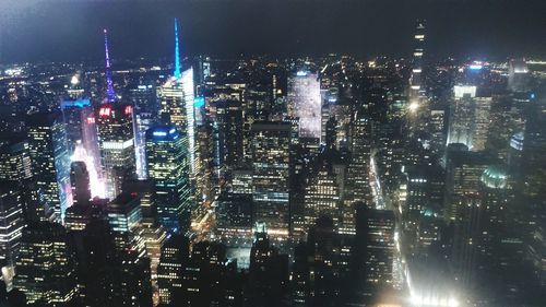 High angle view of illuminated buildings in city at night