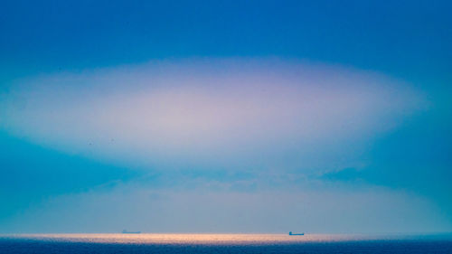 Scenic view of sea against blue sky