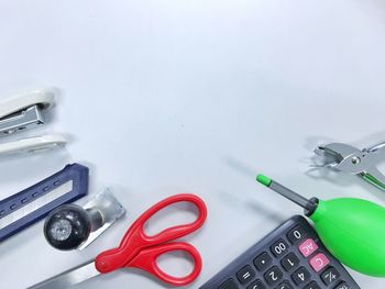 Directly above shot of office supplies on blue background