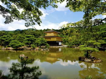 Scenic view of lake by building against sky