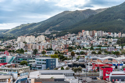 High angle view of townscape by mountains against sky
